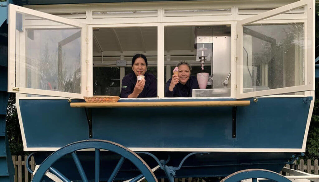 The wagon , small food spot at forge mill farm set in restored old omnivan where two ladies are seen holding ice creams