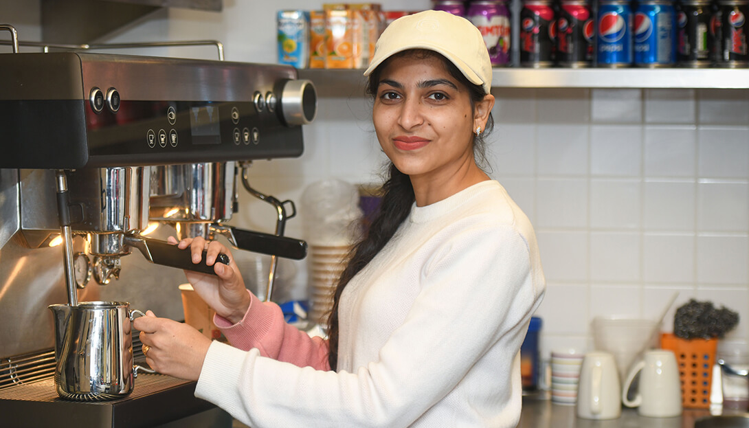 The pavilion at Dartmouth park where a lady is seen operating a coffee machine