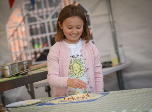 a girl preparing pizza at the farm kitchen